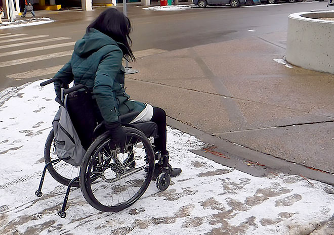 Street corner, snow and mobility challenges.