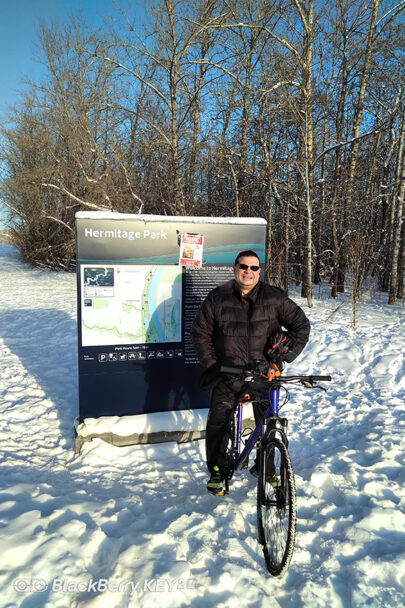 A man sits on his bike in the snow at Hermitage Park.